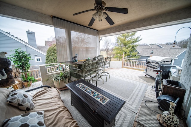 wooden terrace featuring outdoor lounge area, grilling area, and ceiling fan