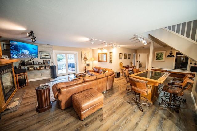 living room featuring a large fireplace and hardwood / wood-style flooring