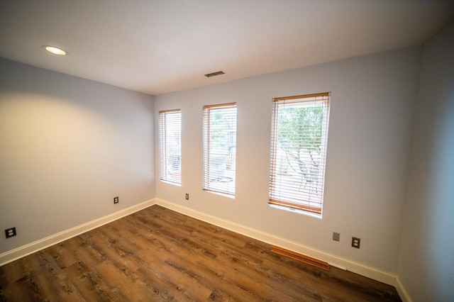 spare room with dark hardwood / wood-style floors