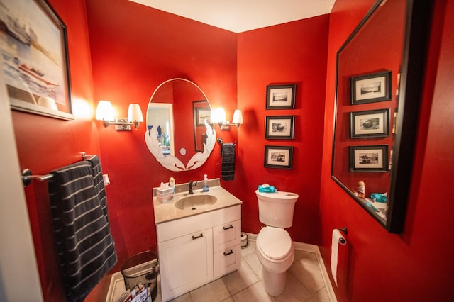 bathroom with tile patterned flooring, vanity, and toilet