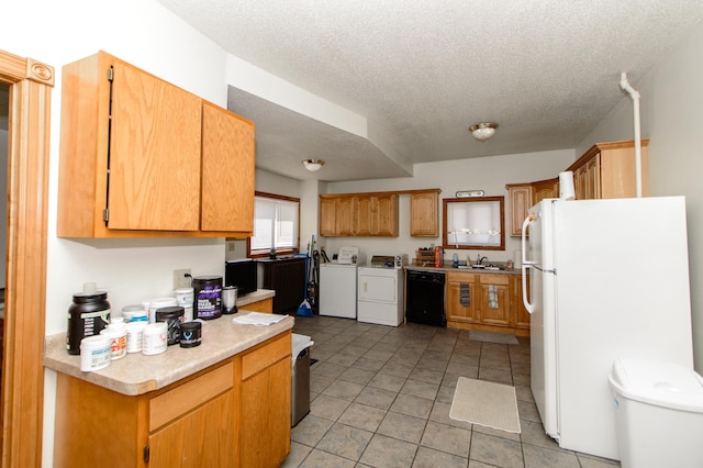 kitchen featuring white refrigerator, light tile floors, independent washer and dryer, dishwasher, and a textured ceiling