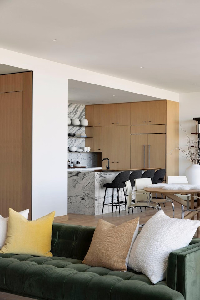 living room featuring sink and wood-type flooring