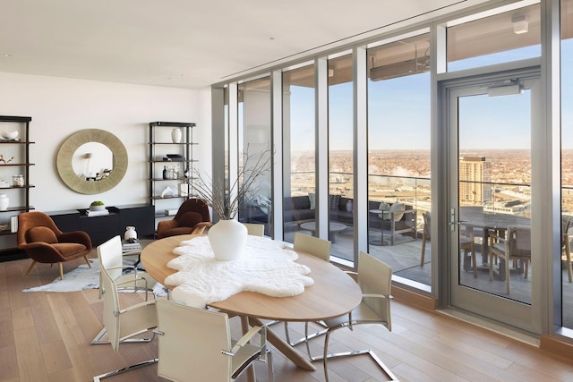 interior space featuring floor to ceiling windows and light wood-type flooring