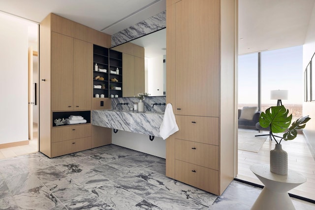 bathroom featuring expansive windows and tasteful backsplash