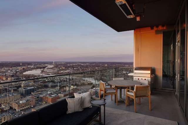 balcony at dusk featuring grilling area