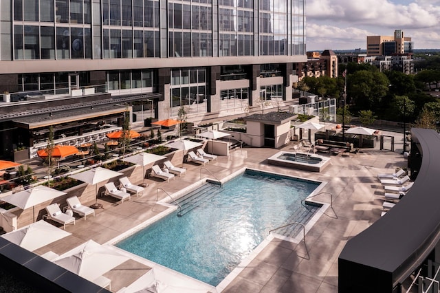 view of swimming pool featuring a patio and a community hot tub