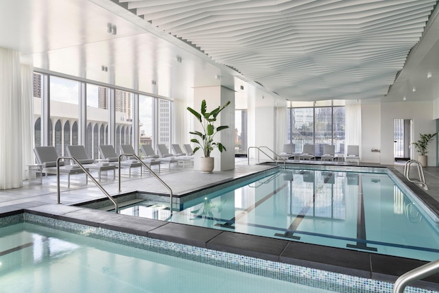 view of swimming pool featuring an indoor hot tub