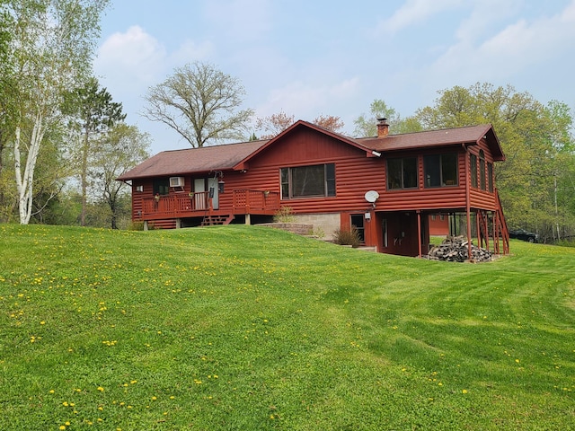 back of property featuring a deck and a yard