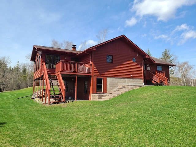 back of property featuring a wooden deck and a yard