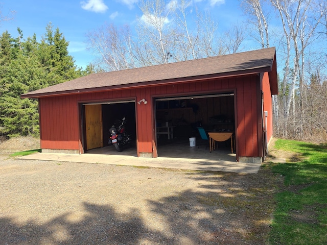 garage featuring wooden walls