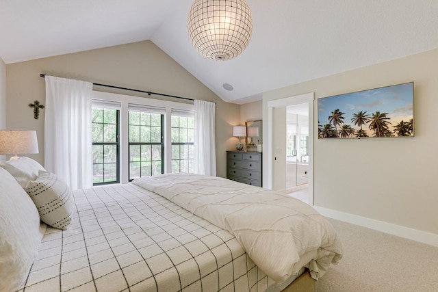 bedroom featuring lofted ceiling, ensuite bathroom, and light colored carpet