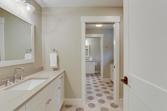 bathroom featuring large vanity and tile flooring