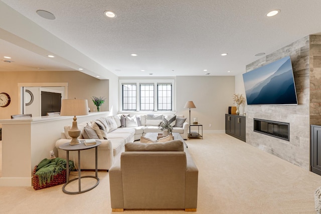 carpeted living room featuring a textured ceiling