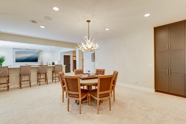 dining room featuring light colored carpet and a notable chandelier