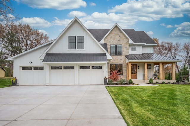 modern farmhouse featuring covered porch, a front yard, and a garage