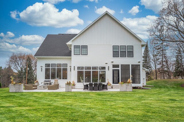 rear view of house with a lawn, outdoor lounge area, and a patio