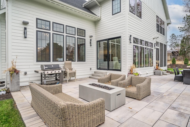 view of patio with area for grilling and an outdoor living space with a fire pit