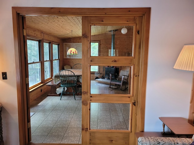 interior space featuring wood ceiling and light tile floors