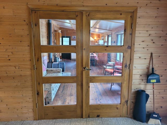 interior details featuring wood walls and light tile flooring