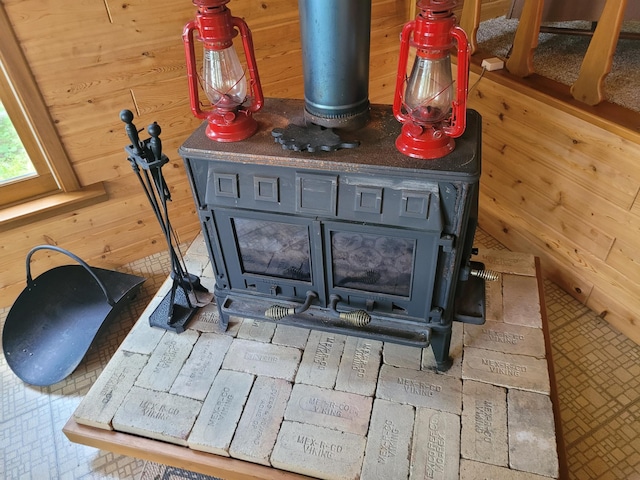 details featuring wood walls and a wood stove