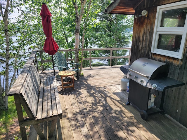 wooden terrace featuring a grill