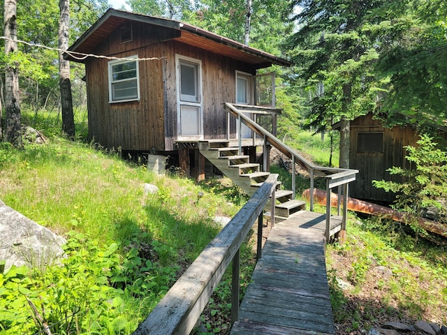 rear view of property with an outdoor structure