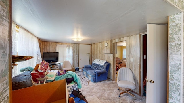 interior space featuring light carpet and wood walls