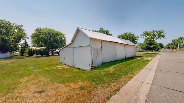 view of outbuilding with a lawn