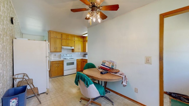 1003 Grand St SE, Chatfield, MN 55923 - kitchen featuring white appliances, light floors, light countertops, a ceiling fan, and under cabinet range hood