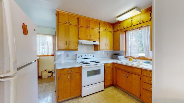 kitchen featuring white appliances and sink