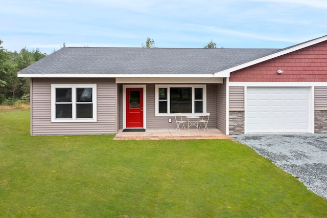 single story home with a garage and a front lawn