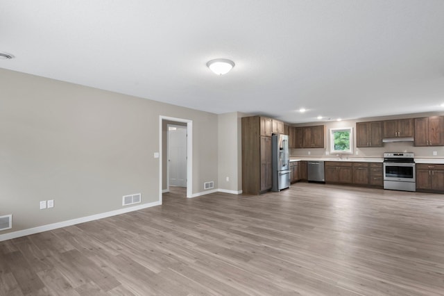 kitchen with light wood-type flooring and stainless steel appliances