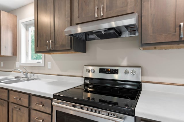 kitchen featuring stainless steel electric range and sink