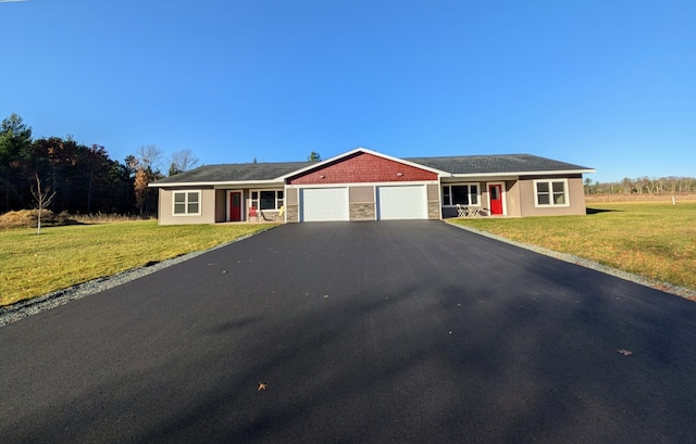 ranch-style home featuring a garage and a front lawn