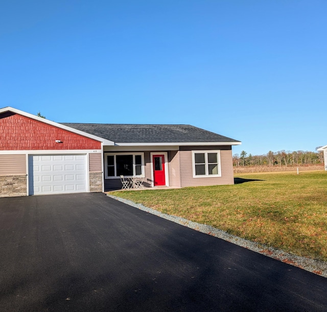 ranch-style home featuring a garage and a front yard