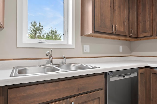 kitchen with stainless steel dishwasher, sink, and dark brown cabinetry