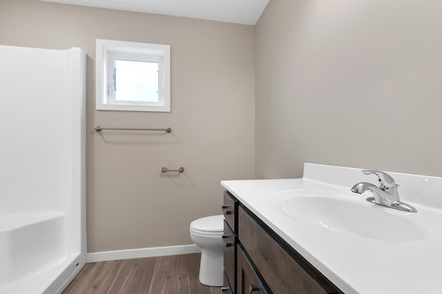 bathroom featuring wood-type flooring, vanity, and toilet