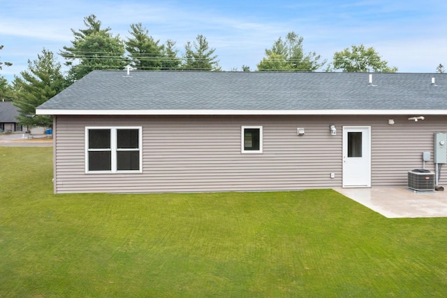 back of house featuring a patio, a lawn, and central air condition unit