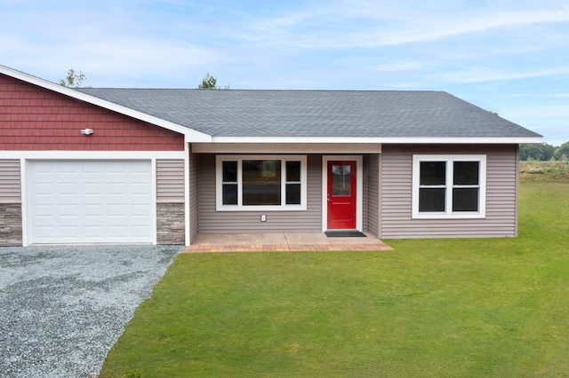 ranch-style house with a garage and a front lawn