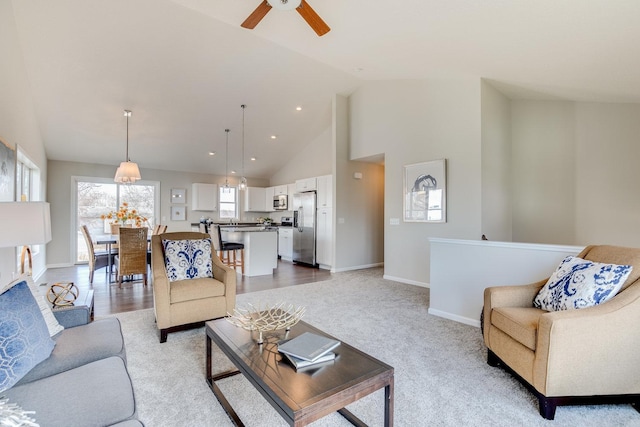 living room featuring light carpet, high vaulted ceiling, and ceiling fan