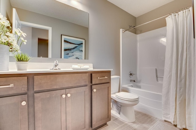 full bathroom featuring tile floors, a textured ceiling, toilet, vanity, and shower / bath combo