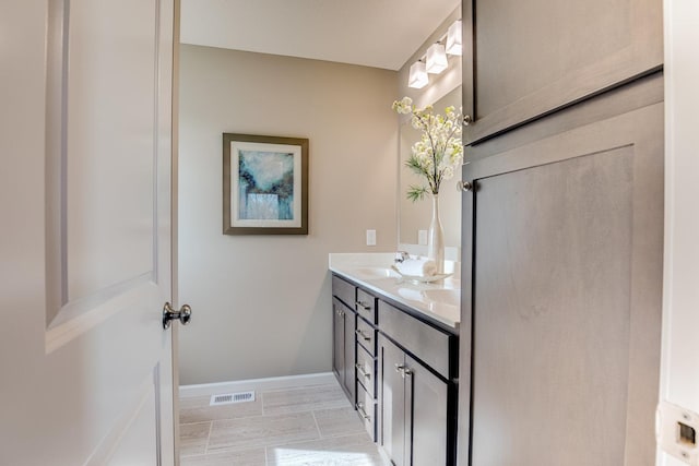 bathroom featuring double sink vanity and tile floors