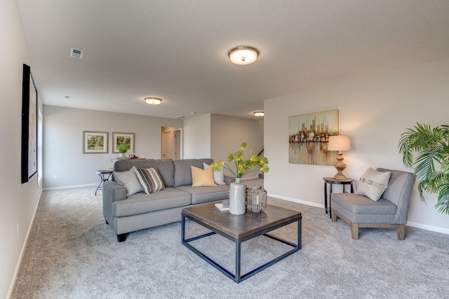 living room with light colored carpet and a textured ceiling