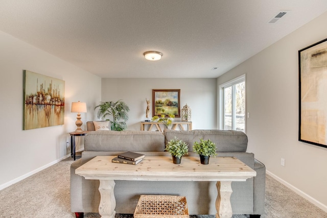 living room with light carpet and a textured ceiling