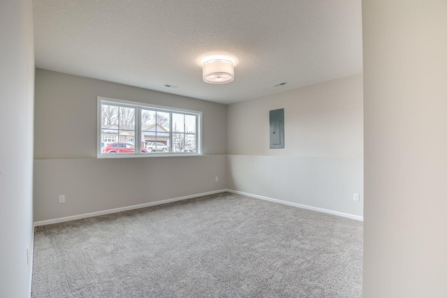 empty room featuring light carpet and a textured ceiling