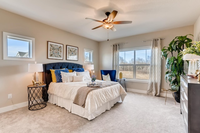 bedroom featuring ceiling fan and light carpet