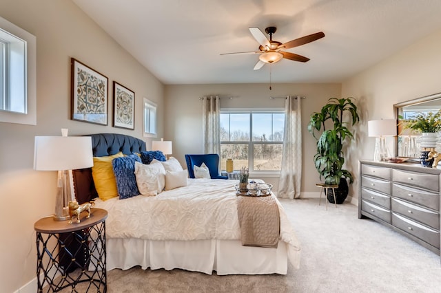 bedroom featuring ceiling fan and carpet