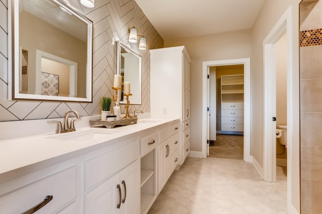 bathroom with vanity, toilet, and tile patterned floors