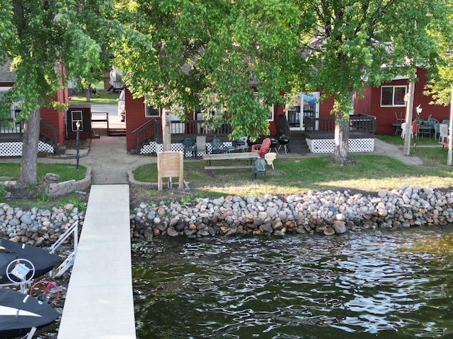 dock area featuring a deck with water view