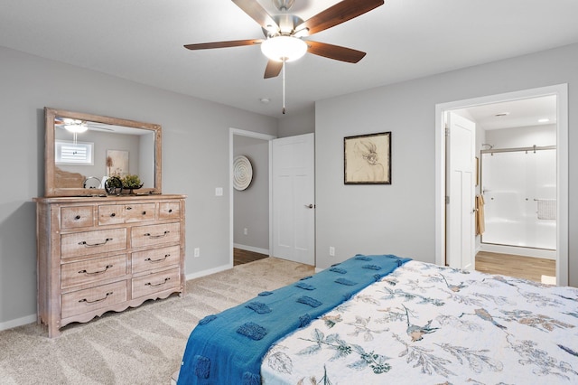 carpeted bedroom with ensuite bath and ceiling fan